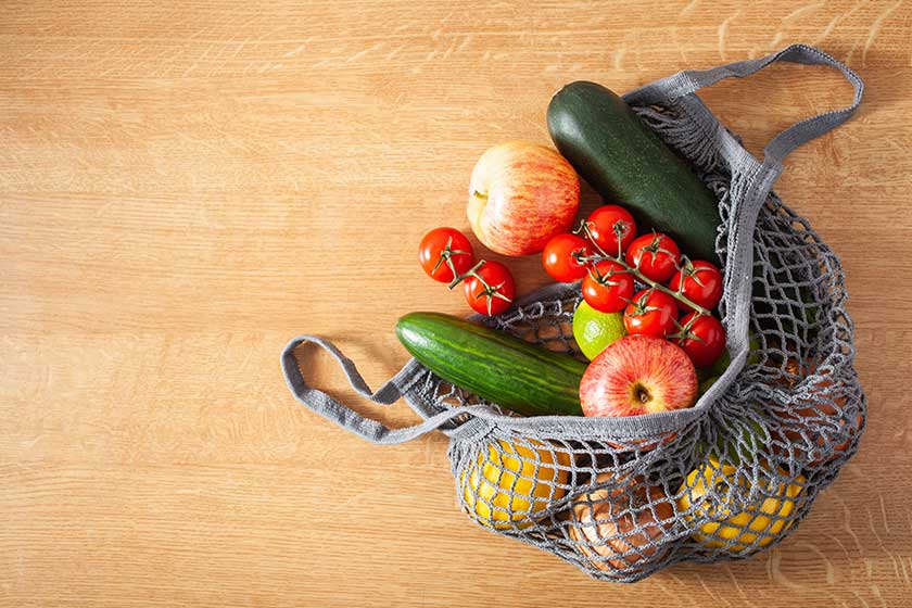 Fruits vegetables in reusable mesh cotton bag, plastic free zero waste concept