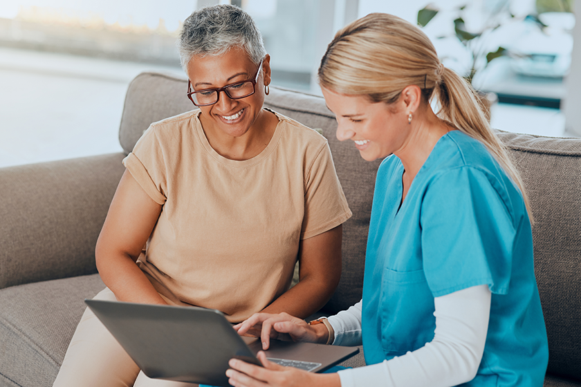 Laptop, healthcare and assisted living with a woman and nurse talking about test results in a retirement home. Computer, medicine and medical with a female health professional and patient in a house.